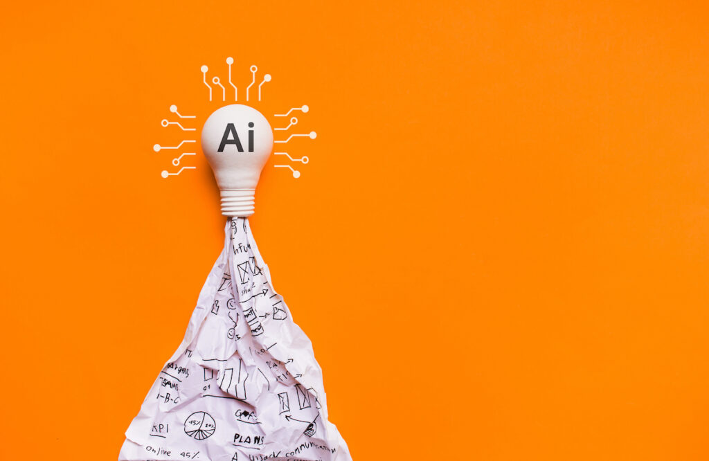 Light bulb that reads "AI" on a bright orange background
